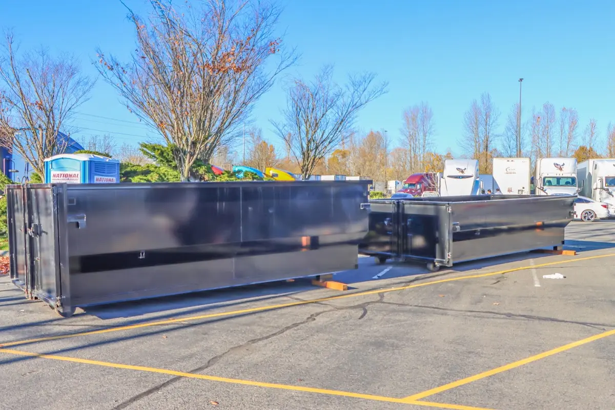 Professional dumpster rental service with roll-off container on residential driveway in Saugerties